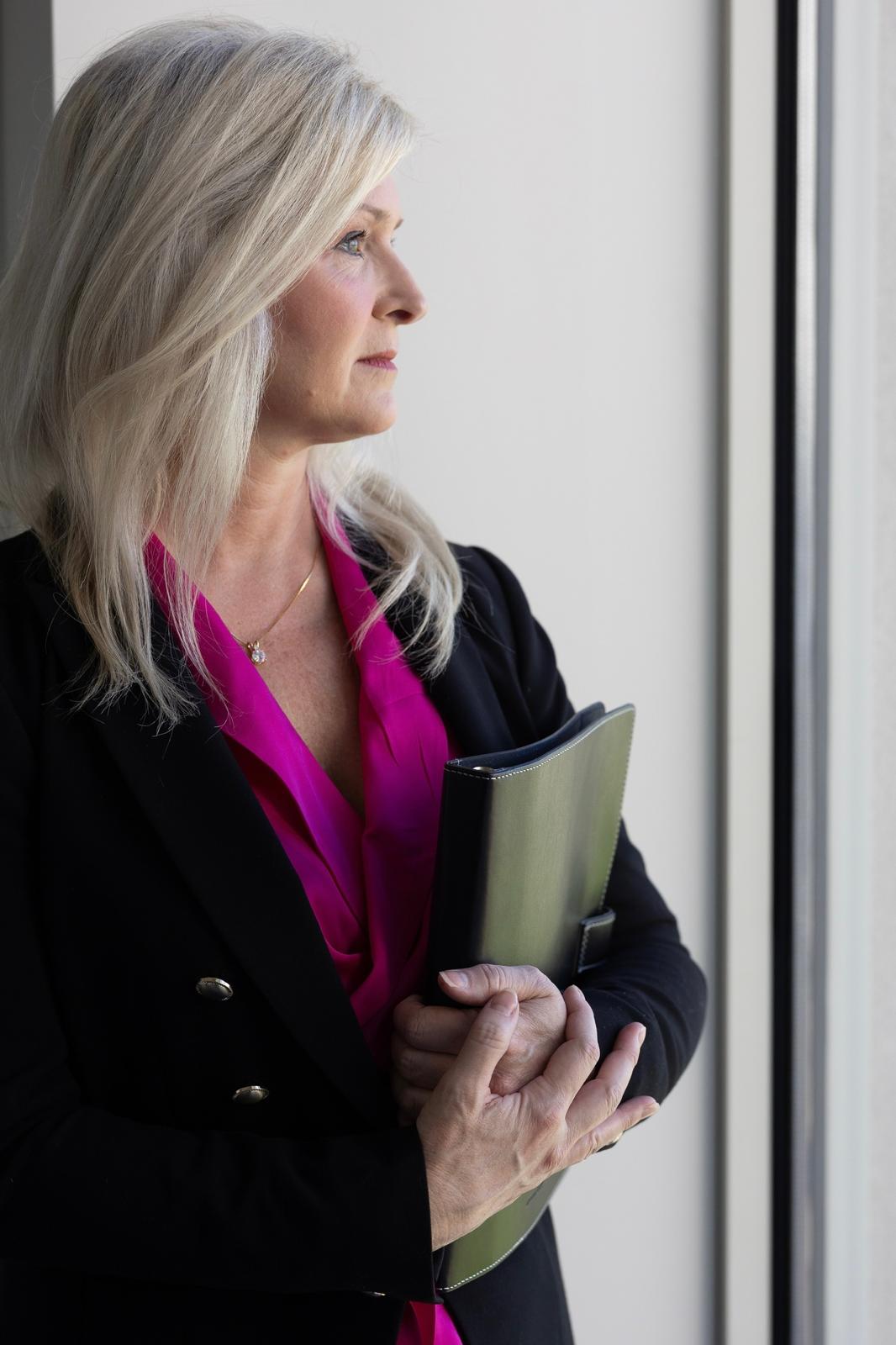Anne Peterson, North Carolina real estate agent, looking out a window
