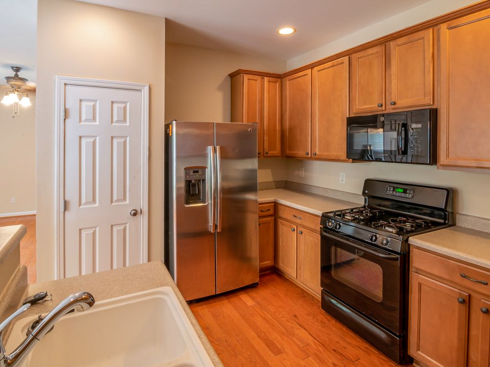 Updated kitchen with warm wood cabinetry